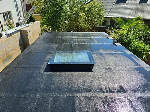 Flat roof with a fitted glass rooflight and new blockwork upstand
