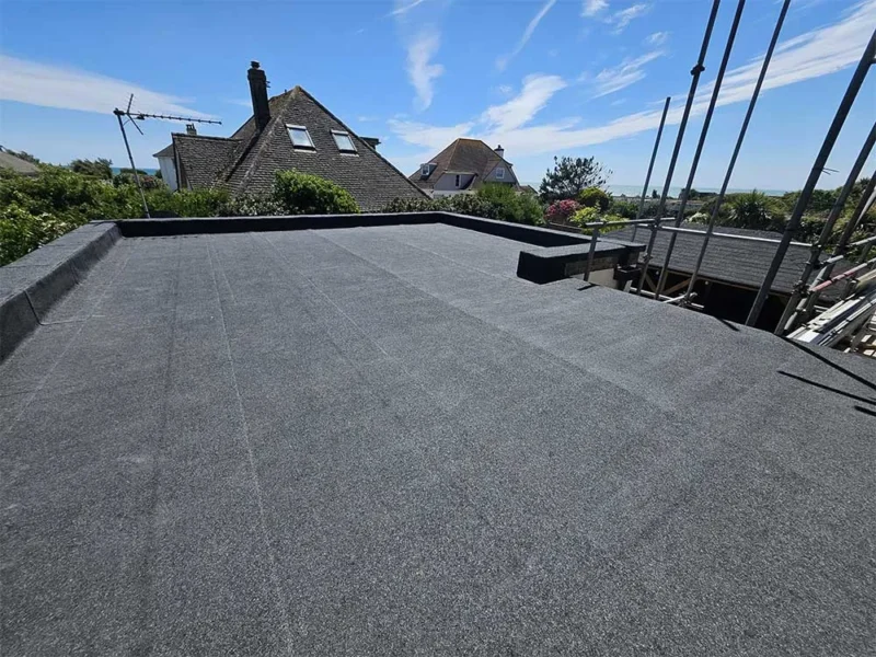 Newly felted flat roof extension with a sweeping view over chimney pots and coastal rooftops